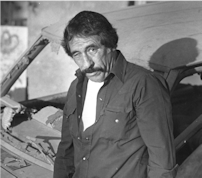 Pablo Acosta -- photo taken by author Poppa only days after Acosta was in a ranch shootout. He's standing in front of Ford Bronco shot to pieces in fray. Acosta wounded/rival killed.