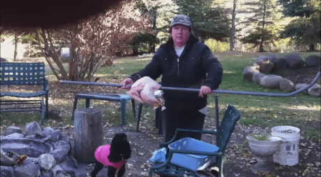 The turkey is secured to the rotisserie rod and ready to be placed on the 2 large wooden blocks that I have set up beside my fire pit.