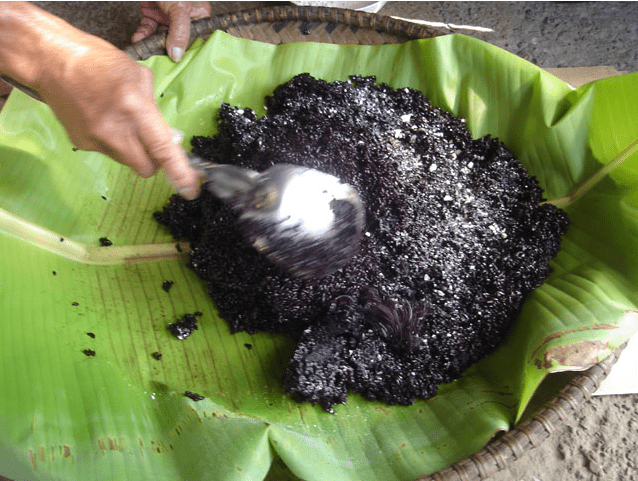 Mix the cooked rice to distribute the bubod (Image Credit: Photos by Jun Verzola and Brenda Dacpano/NORDIS from galleries.nordis.net)
