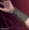 Bracers made out of armor-grade stainless steel and fastened with leather laces. One was made for each arm, weighing 1/2 pound each.