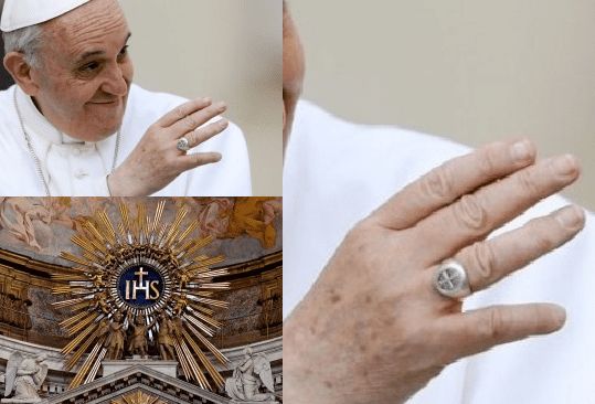 Pope Francis who is a Jesuit, with a cross on his ring.The cross/mark of Dan on Pope Francis's ring IHS of the Jesuit order, with the cross in a sun blaze. IHS = in hoc signo, in this sign, the Cross they shall conquer.