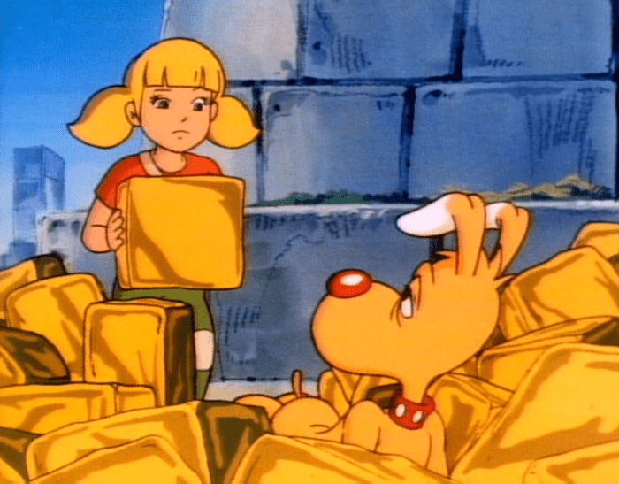 Penny holds up a fake black of gold while Brain is looking around the area after having fallen down.