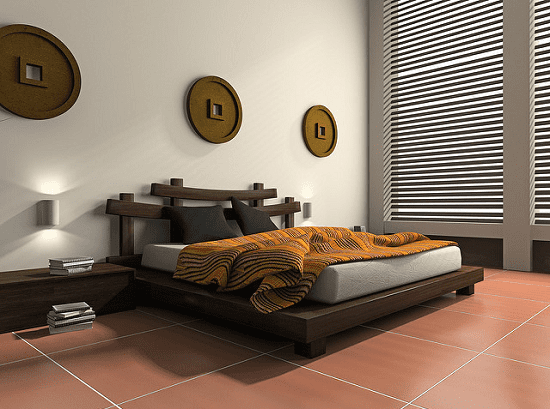 A modern bedroom with an ethnic touch. Notice the wall art, headboard, and bedspread - all ethnic elements, set in a modern bedroom with clean hard floor, modern wall sconce, and Venetian blinds.