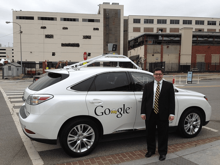 FCC Commissioner Michael O'Rielly standing next to Google's self-driving car ( April 28, 2014); now Waymo (Alphabet), began as the Google Self-Driving Car Project in 2009.