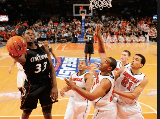 Classic picture of Lance, tongue out and finger rolling past four Louisville defenders at Madison Square Garden in New York