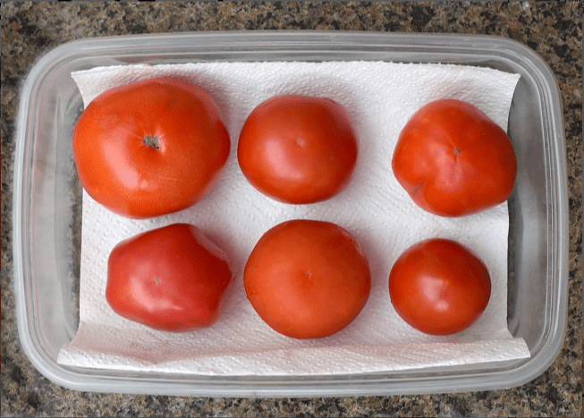 A good rule of thumb is to store all whole and green tomatoes at room temperatures of 60 degrees or above.