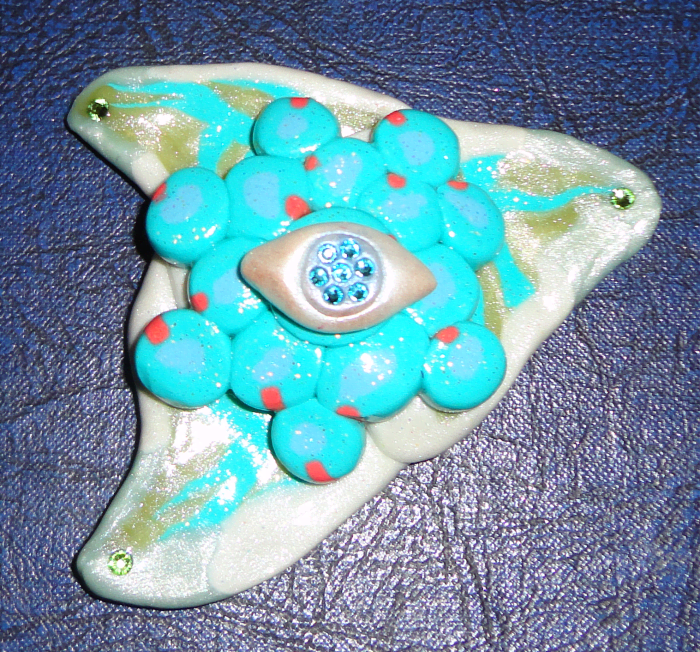 Varathane does more than bring out the details, especially in "special effect" clays like pearl and glitter. It can be used as a glue to attach small objects (like tiny crystals) that can be baked at low temps. (The eye is from two part epoxy clay.)