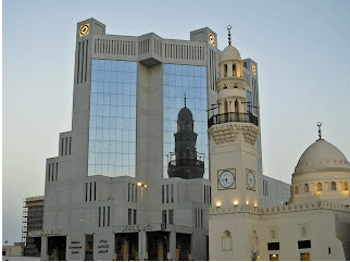 Bahrain Telecommunications Building (Batelco) - shows a magnificent reflection of the old mosque' minaret against its modern glass architecture