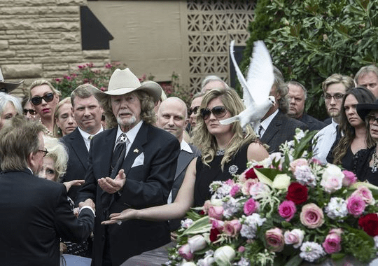 Family members of Lynn Anderson release a dove by her casket after the service on Wednesday