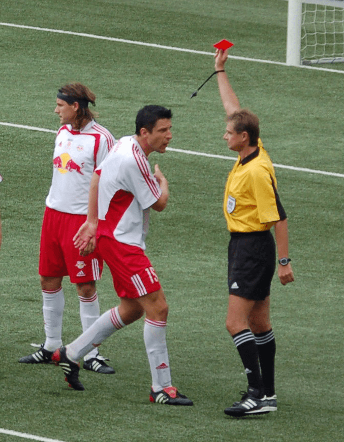 When the referee gives a player a red card, that player is dismissed from the match immediately. Coaches can also be given red cards.
