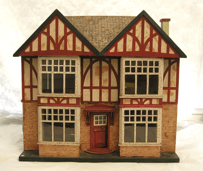 Dollhouse with papered brick work & roof tiles referred to as butter box doll's houses. Lithographed paper representing red brickwork and roof tiles were produced by companies like Hobbies and Handicrafts Ltd, Great Britain
