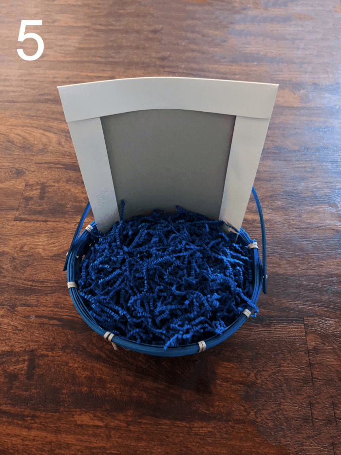 5. Fill with grass or paper shreds. (I used paper shreds in this case. The dollar store didn't have the color Easter grass that I wanted.)
