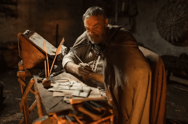 John Rhys-Davies (from Lord of the Rings) as Bishop Patrick writes a letter in the docudrama "I Am Patrick" via Fathom Events