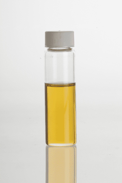 The inset shows an essential oil carrier bottle. Turmeric essential oil should be stored in a glass dispenser.