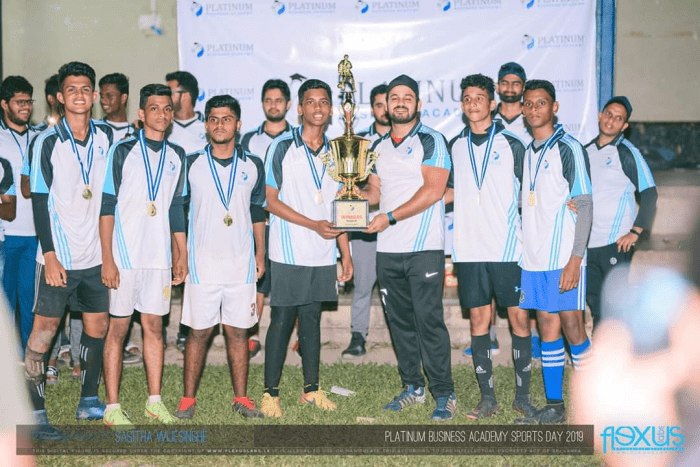 The ‘Soththis’ receiving their trophy, after emerging victorious at an academy sports day. Shayan is on the far right, wearing a medal