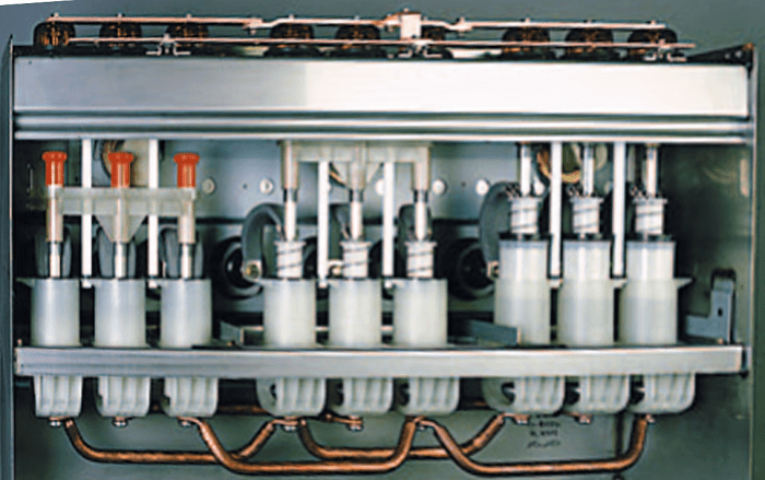 The Schneider Electric's RM6 RMU pictured from backside with covers removed. The main Common bus bar is visible exposed at the bottom, whereas the earth bus bar is at the top.