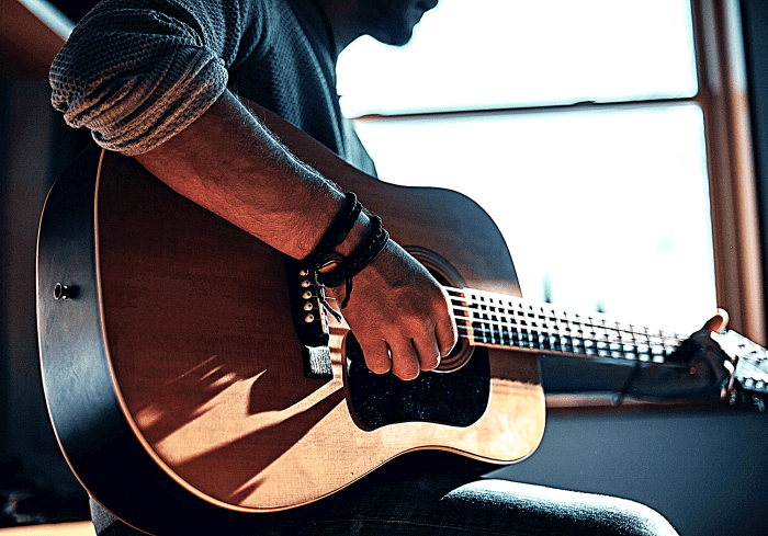 There is a ton of free information online about playing guitar, including lessons. You can learn anything you need to know from your computer.