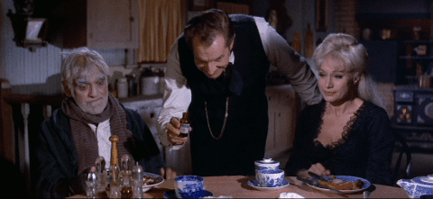 What's a little poison between friends? Vincent Price (standing) doses Boris Karloff as Joyce Jameson dreams of songs to murder.