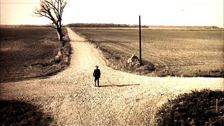 A picture of a man standing at a crossroads