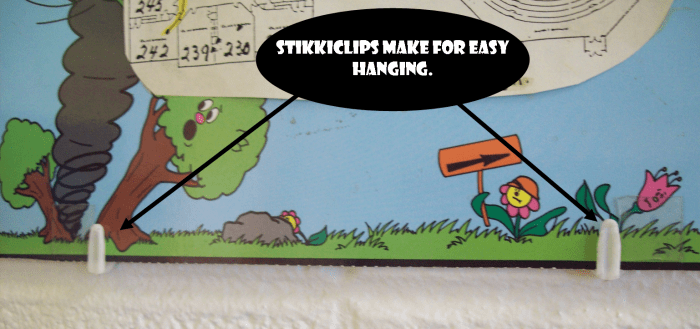 StikkiClips make it easy to hang artwork on just about any wall. The one in the background here is cinder-block.
