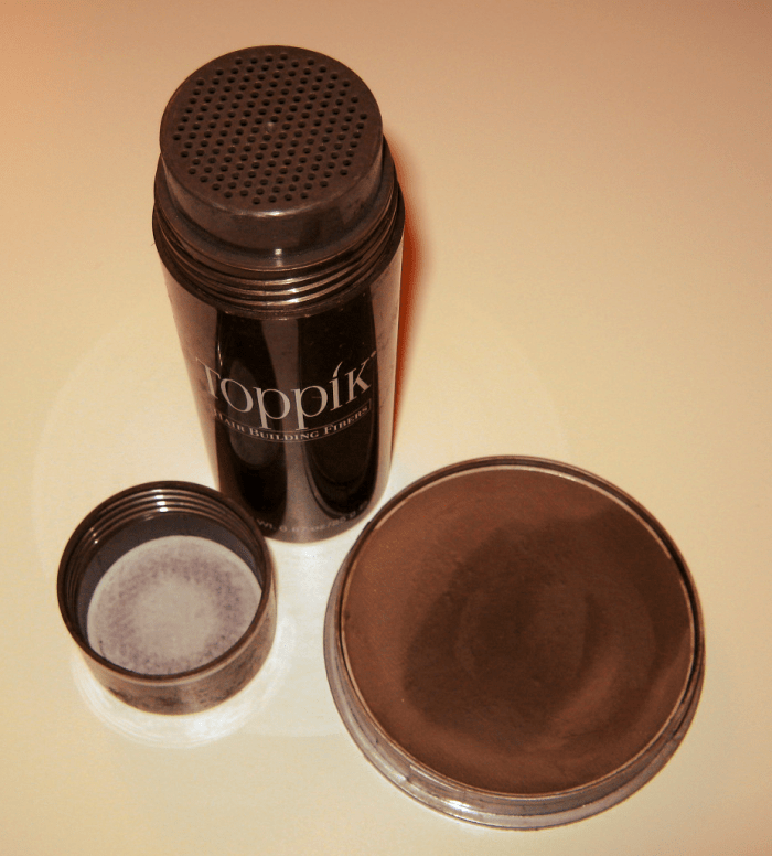 Hair building fibers in a shaker container (left) and water-activated hair loss concealer (right).