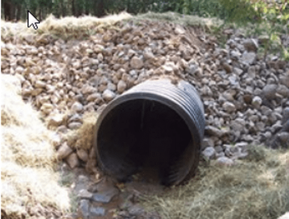 Notice the dark material in the culvert. Many times the material consists of "black sand", hematite, magnetite, lead and other heavier metals that collect along with gold.