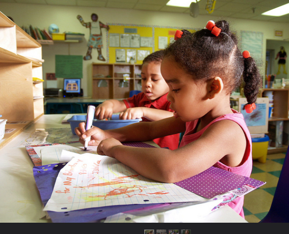 A writing center promotes meaningful writing: posters, signs, cards, letters, and lists.