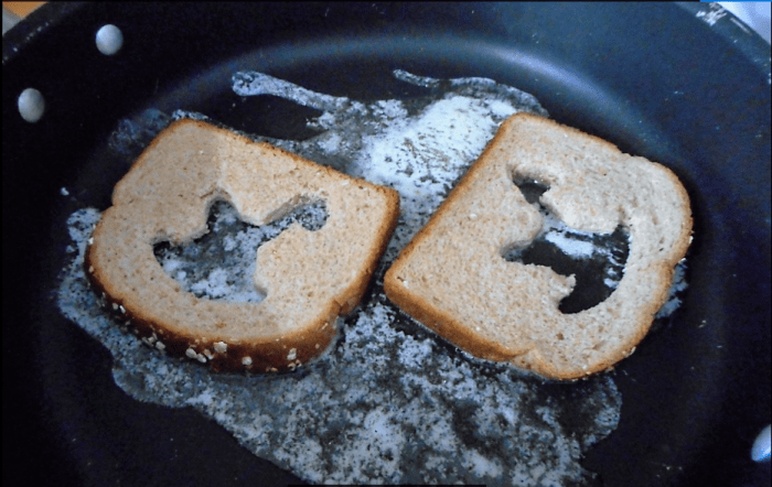 Butter needs to go in a large frying pan on medium heat. When the butter has melted, it's time to place the bread on the butter.