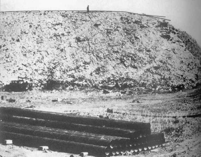 A ground view of the Corona Ash Dumps. That black spot on the top of the mound is a human, giving you an idea of how tall these mounds grew to. And by this time the entire dump was filled with these giant mounds.