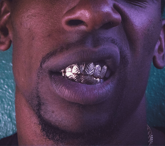 Grillz, tooth gems, dentures, false teeth, vampire fangs... any of these "extra" dental ornaments might be hiding something.
