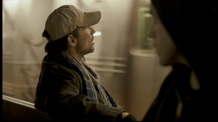 Elliot and the mysterious man on the train have a conversation on the train terminal. Image copyright of USA Network.