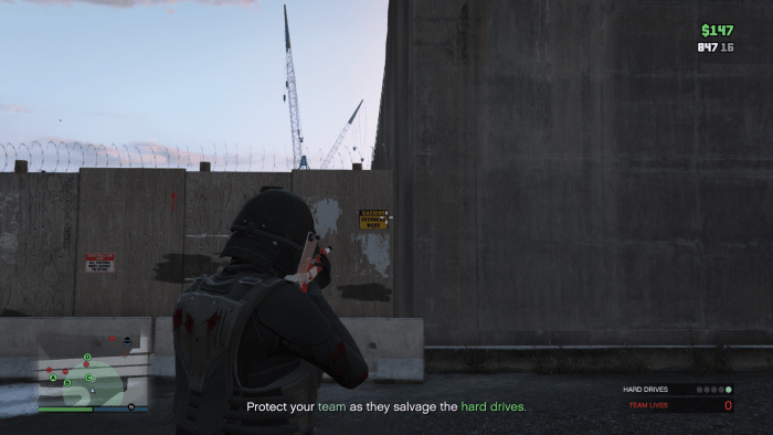 Once around the other side you can climb over this wall to get back into the area with all of the wrecked vehicles. Note: Hop onto the cement divider THEN climb the wood wall if you're having trouble.