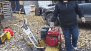 I put the gasoline that I took out of the old engine into the replacement engine and check the engine oil by removing the 3/8" plug in the bottom of the engine crankcase.