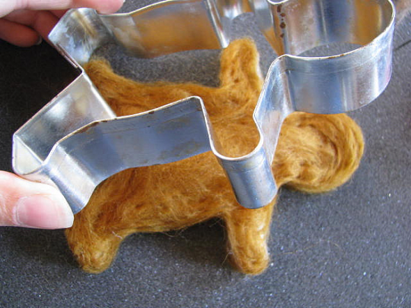 Felting the wool roving inside a cookie cutter is a clever idea for easily getting a perfect shape.