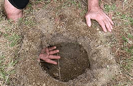 Where you see his hand is the breathing hole for your fire hole. This method used burns firewood more efficiently puts out more heat and very little smoke.