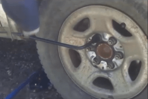 To complete the lug nut tightening give the wheel wrench handle a slight kick downward with your foot