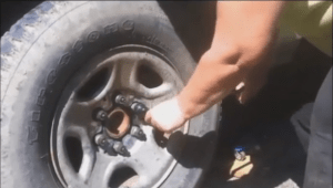 With both hands on the horizontal handle of the wheel wrench use all of your upper body weight to push downward until the lug nut refuses to turn.