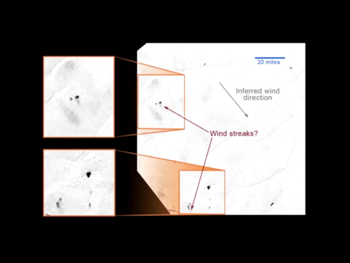 Wind deposits on the backsides of obstacles, or... plume deposits from a geyser? VERY speculative; we don't know yet. (Screengrab from streaming video, and the original image had JPG compression artifacts, so take details with a grain of salt)