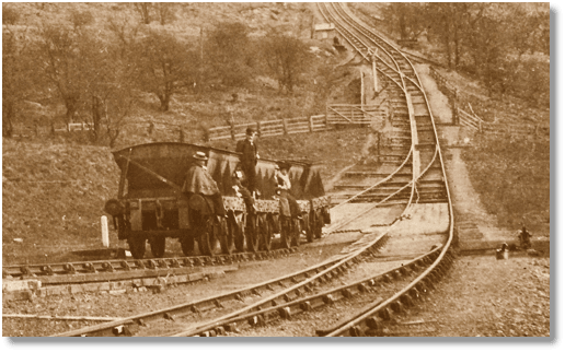 Near Incline Bottom, a rake of 8 ton steel mineral wagons carries 'passengers' up the incline past the weigh hut