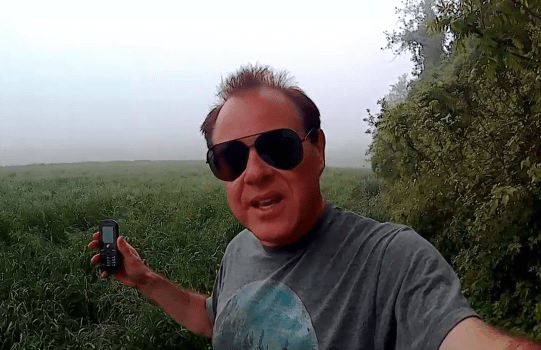 Gary using his Tracfone in a field to capture EVPs from spirits or other interdimensional beings