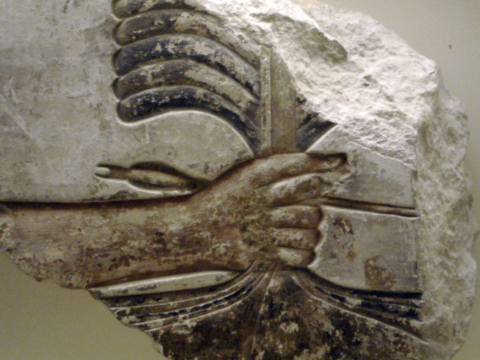 Close-up of Senwosret I grabbing the enemies of Egypt by their hair.