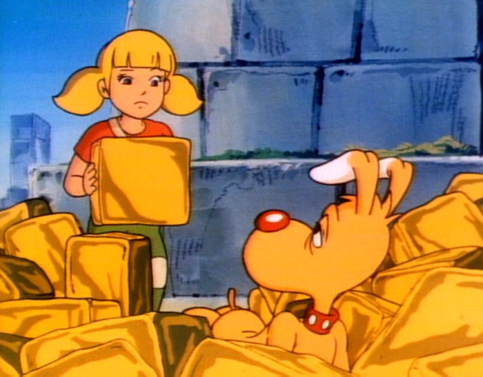 Penny holds up a fake black of gold while Brain is looking around the area after having fallen down.