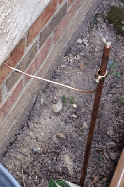 The gas line can also be grounded outside the home by attaching the #6 copper wire to the black iron pipe outside and burying the grounding rod or pipe eight feet into the ground.
