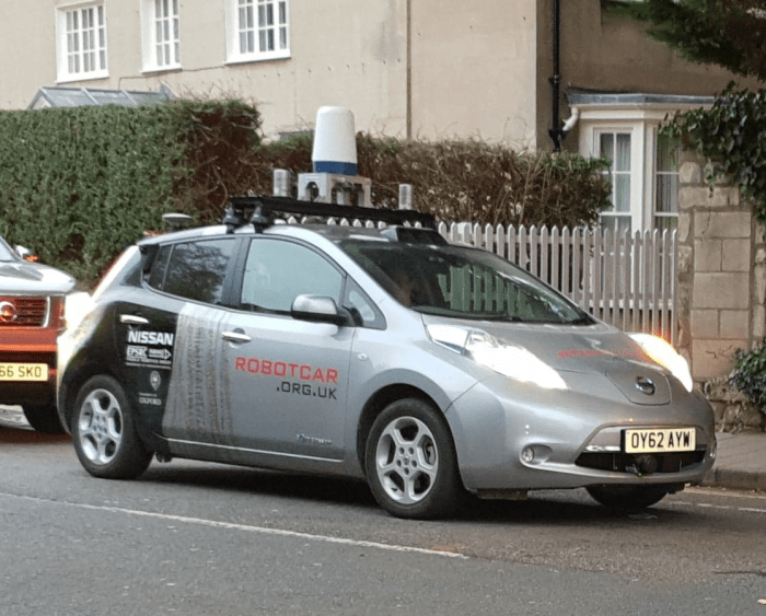 Modified Nissan Leaf used for research by the Mobile Robotics Group, Oxford Robotics Institute. Shown on the streets of Oxford, United Kingdom, the robot car has sensors that include radar, LIDAR, and cameras.
