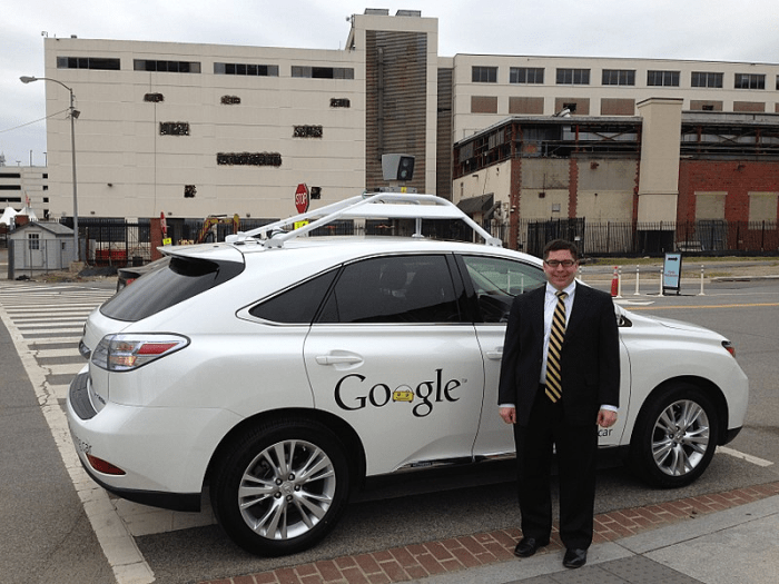 FCC Commissioner Michael O'Rielly standing next to Google's self-driving car ( April 28, 2014); now Waymo (Alphabet), began as the Google Self-Driving Car Project in 2009.