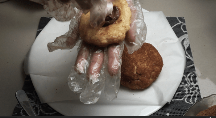 Place a 2 tbsp of cookie dough onto your palm and take 1 teaspoon of chocolate ganache or Nutella if you prefer then you can also add marshmallow or a handful of chocolate chips for extra flavor. Your choice for topping and filling.