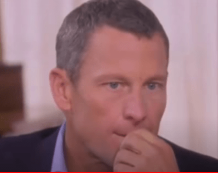 Lance Armstrong touches his mouth while being interviewed by Oprah Winfrey.