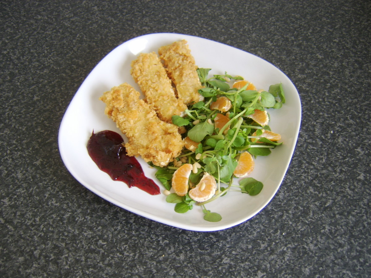 Slices of French camembert, deep fried in fresh breadcrumbs and served with a salad of satsuma, watercress and toasted pine nuts, with cranberry and port sauce