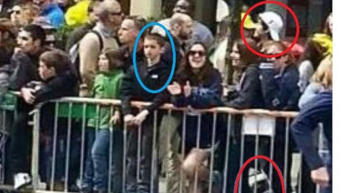 Screen grab by ABC News shows what appears to be Martin Richard, circled left, the 8 year old victim of the Boston Marathon bombings and one of the suspects, circled right, minutes before the bomb went off, April 15, 2013.