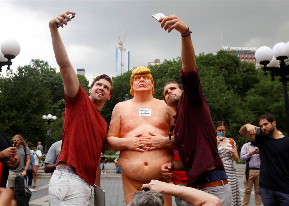 In Union Square, NY, people pose for selfies with a naked Trump statue while the Left remains virtually silent and snickering in the background.